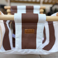 Load image into Gallery viewer, Striped swing with a brand label
