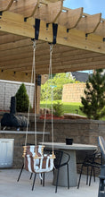 Load image into Gallery viewer, Outdoor patio area with wooden pergola, chairs, and a grill on a sunny day.