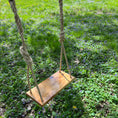 Load image into Gallery viewer, Top angle view of hickory bench swing shown with natural durable brown rope