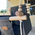 Load image into Gallery viewer, Zoom in view of maple wood dowels ad beads for slate toddler swing shown on outdoor patio