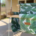 Load image into Gallery viewer, Close-up of tropical leaf print fabric on outdoor swing seat