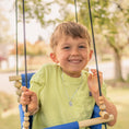 Load image into Gallery viewer, Little Kid in best outdoor swing shown in royal blue with black twisted ropes