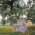 Load image into Gallery viewer, Wheat-colored baby swing hanging in backyard setting