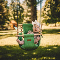 Load image into Gallery viewer, baby in premium outdoor swing in sage green with one pillow and twisted black ropes shown with fray style