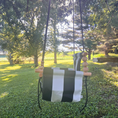 Load image into Gallery viewer, profile view of wide black and cream striped pattern outdoor toddler swing