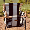 Load image into Gallery viewer, Outdoor baby swing in wide black stripe pattern shown with twisted black rope and 1 pillow