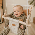 Load image into Gallery viewer, Baby boy using neutral confetti high back swing paired with solid nutmeg pillow