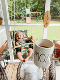 Load image into Gallery viewer, baby using outdoor tropical leaf toddler swing while mom enjoys coffee outdoors