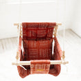 Load image into Gallery viewer, Front view brick red baby swing with high back support, rustic indoor cotton design shown with one pillow