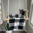 Load image into Gallery viewer, Side view of high back black buffalo check indoor baby swing with wooden beads, safe indoor design