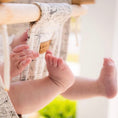Load image into Gallery viewer, close up of baby feet in navigation pattern high back indoor baby swing, durable cotton