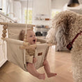 Load image into Gallery viewer, Baby in Greige and Vanilla Stripe pattern, indoor high back cotton baby swing, happy interaction with family pet