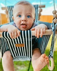 Load image into Gallery viewer, Baby using classic black and white stripe high back swing, shown with optional toy /teether ring