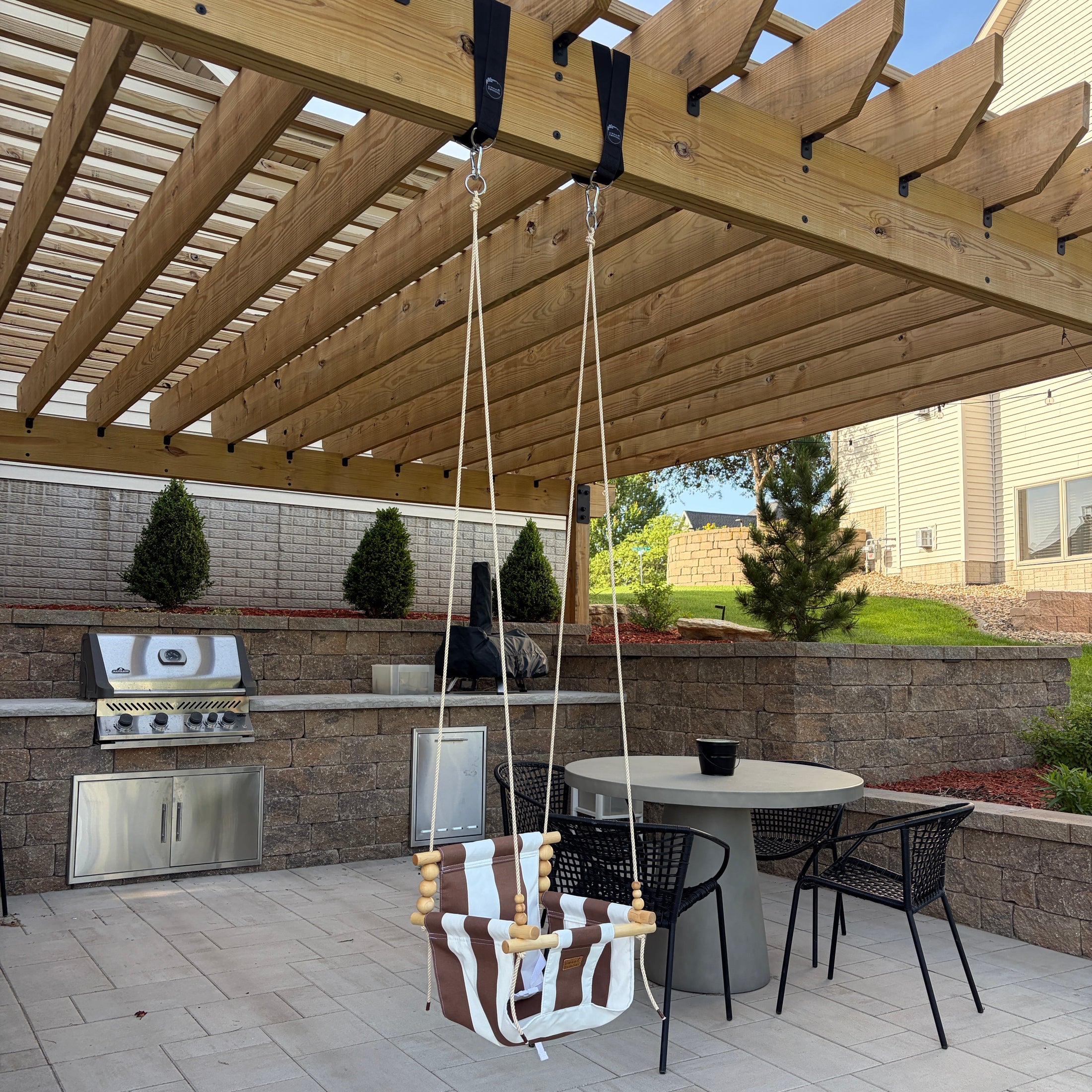 brown and white striped swing in backyard patio
