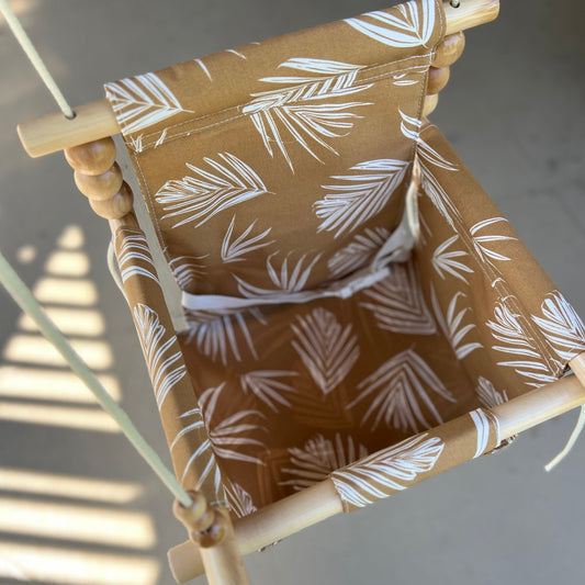 Detailed view of nutmeg leaf print on baby swing fabric

