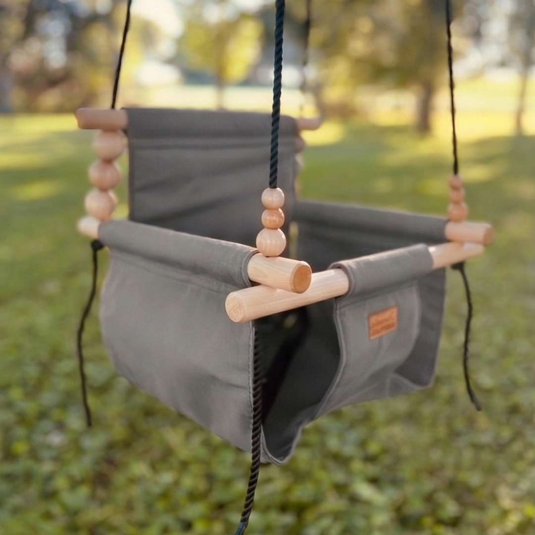 Premium outdoor baby and toddler swing in grassy shady back yard shown in color stone