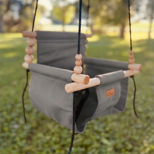 Premium outdoor baby and toddler swing in grassy shady back yard shown in color stone