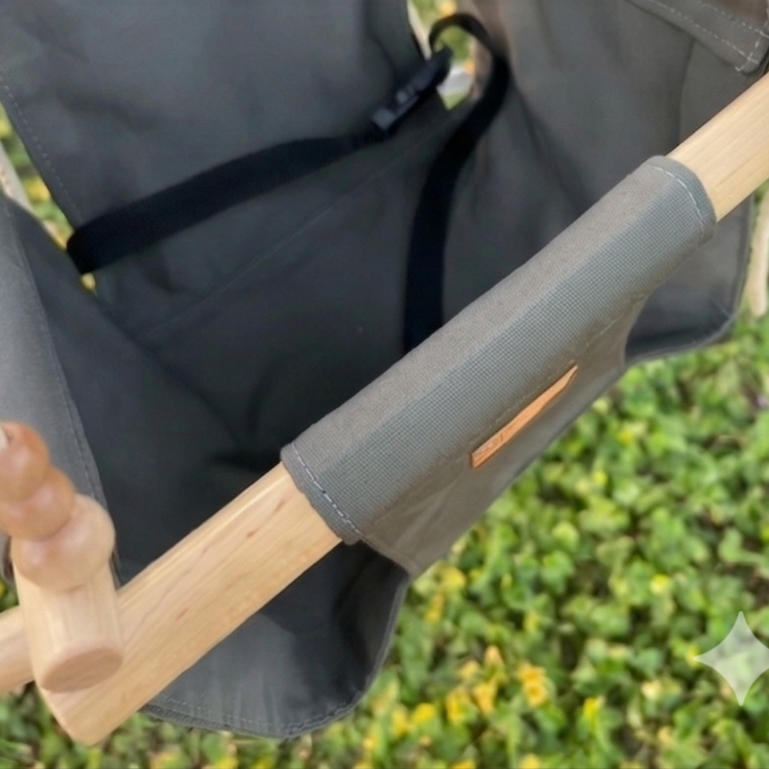 Close-up of a wooden handle with gray colored swing on a chair, blurred green background