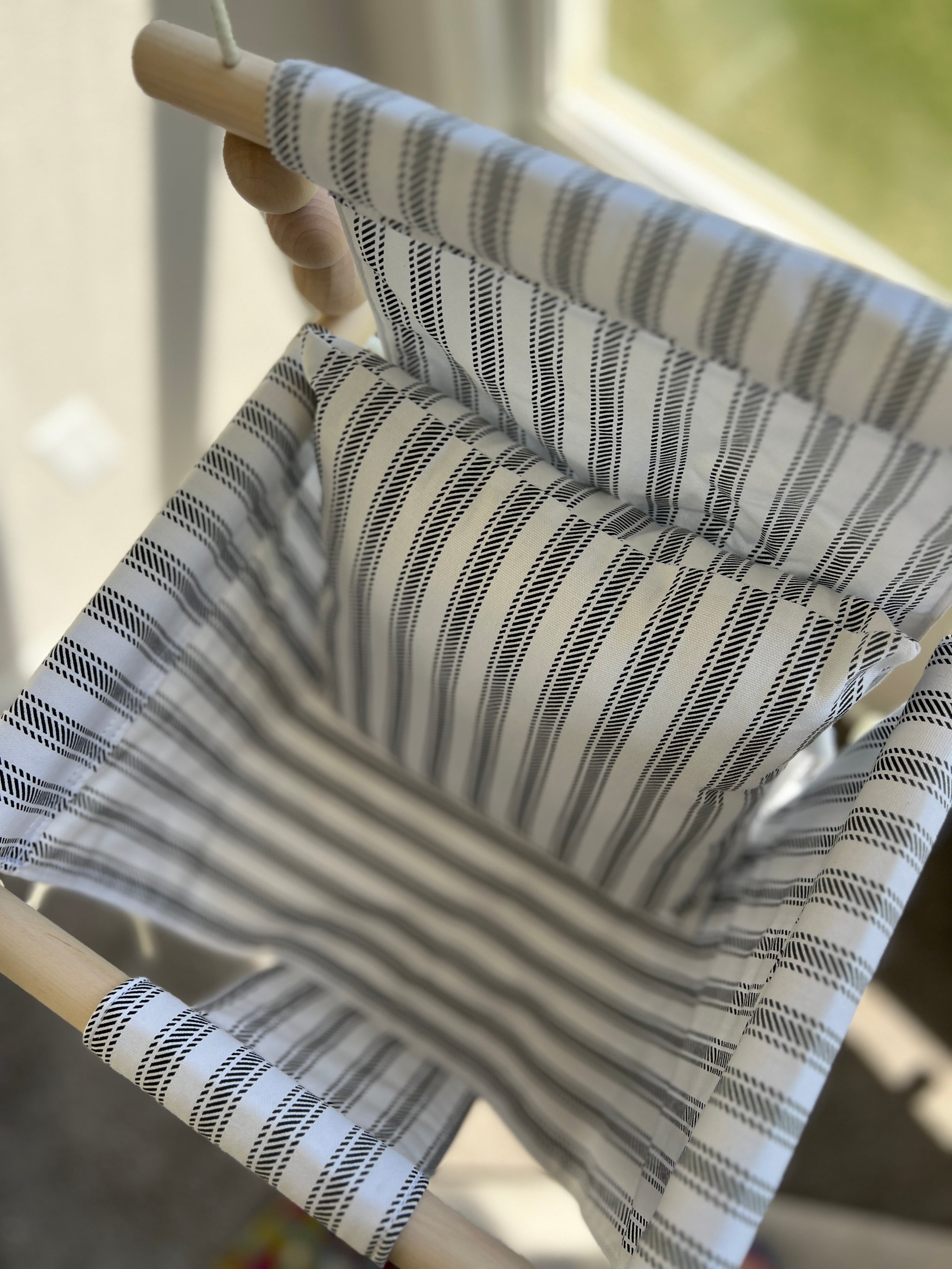 Top view of wide  ticking stripe baby swing with one pillow option